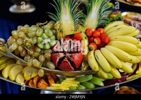 Eine Platte gefüllt mit verschiedenen frischen Früchten, darunter Trauben, Bananen und Ananas Stockfoto