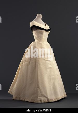 Jeanne Lanvin (1867-1946) und Castillo (Antonio Canovas del Castillo del Rey, dit) (1908-1984); Marke: Jeanne Lanvin - Castillo. Abendkleid. Übersicht über Dreiviertel vor dem Otopan gerippten Organ, gefolgt von Rhodia, Rhovyl und Wolle des Hauses Lamarre Elfenbein, Seidensatin (?) Schwarz. Frühjahr-Esté 1954. Galliera, Modemuseum der Stadt Paris. Facron, Haute Couture, Elfenbein, Wolle, Lanvin-Castillo, Lamarre House, Femininer Modus, Schwarz, Osmanisches Knabbern, Spring-Ete 1954, Rhodia, Rhovyl, Abendkleid, Satin, Seide, Suiten mit Orgeln, Blick auf Trois-Quarts Stockfoto