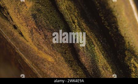 Farbe mit Glitzertinte und Farbverlauf in goldfarbenem Schwarz Stockfoto
