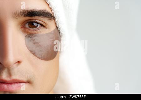 Porträt eines attraktiven jungen männlichen Modells mit Augenflecken auf weißem Hintergrund Stockfoto