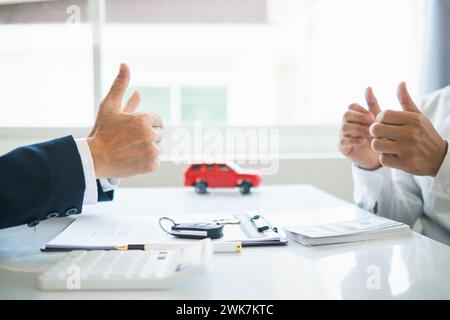 Autohändler bieten Kunden Werbeaktionen an und berechnen die Kosten für das Leasing eines neuen Elektrofahrzeugs. Käufer haben sich bereit erklärt, Elektrofahrzeuge von d Stockfoto