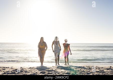 Drei junge Frauen genießen einen sonnigen Tag am Strand Stockfoto