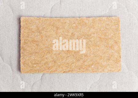 Eine rechteckige Probe aus thermpresstem Filz, die bei der Herstellung moderner Matratzen mit unabhängigen Federblöcken verwendet wird. Draufsicht. Stockfoto