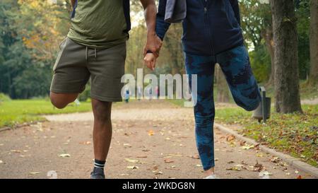 Glückliche Freunde Arabian People Indianerpaar Frau im Stadtpark im Freien auf einem Bein stehend Versuchen Sie Balance Strecken Hüften Beine Aufwärmen Workout Sport Stockfoto