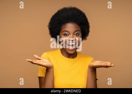 Fröhliche, charismatische Afrikaistin, amerikanische Frau mit fröhlichem Gesichtsausdruck, breit lächelnd, Blick in die Kamera Stockfoto