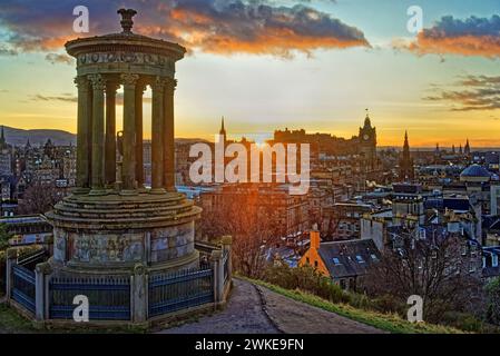 Großbritannien, Schottland, Edinburgh, Calton Hill, Dugald Stewart Monument und Sonnenuntergang über dem Stadtzentrum von Edinburgh. Stockfoto