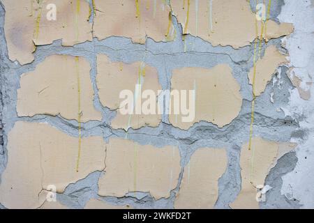 Große gelbe Flecken von alter Farbe auf verwittertem grauen Beton. Die Wirkung zerstört. Stockfoto