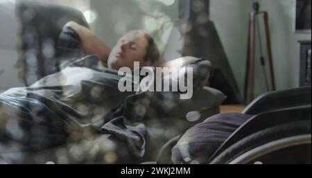 Bild von Lichtflecken über behindertem kuakasischem Mann, der im Bett liegt Stockfoto