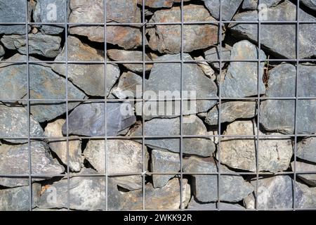 Natursteinmauer mit Eisengitter Stockfoto