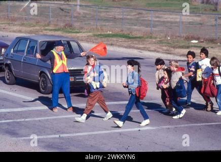 Austin, Texas, USA: Die Grenzwache an der Kreuzung der Grundschule weist die Schüler an, die Straße sicher zu überqueren. ©Bob Daemmrich Stockfoto