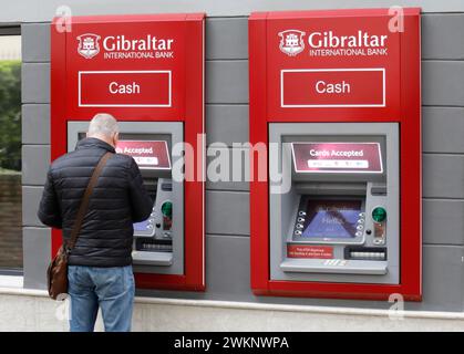 Ein Mann zieht Geld an einem Geldautomaten der Gibraltar International Bank in Gibraltar ab, 14/02/2019 Stockfoto