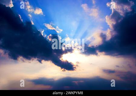 Sonne hinter Wolken und Sonnenstrahlen Stockfoto