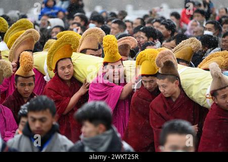 (240222) -- XIAHE, 22. Februar 2024 (Xinhua) -- Mönche tragen ein riesiges Thangka-Gemälde mit dem Bild des Buddha während der jährlichen Zeremonie der 'Sonnensonne des Buddha' des Labrang-Klosters in Xiahe County, nordwestchinesische Provinz Gansu, 22. Februar 2024. Mehr als 40.000 Gläubige und Touristen aus dem in- und Ausland nahmen an einer großen tibetisch-buddhistischen Veranstaltung Teil, bekannt als die Zeremonie der „Sonne des Buddha“, die am Donnerstag im Kloster Labrang in der nordwestchinesischen Provinz Gansu stattfand. Die jährliche Veranstaltung ist eine der wichtigsten Zeremonien im Kloster Labrang, erbaut 1709, einem der sechs großen Tempel Stockfoto