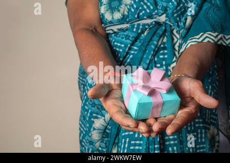 Ältere Indianerin hält Geschenkbox in der Hand, Nahaufnahme Stockfoto