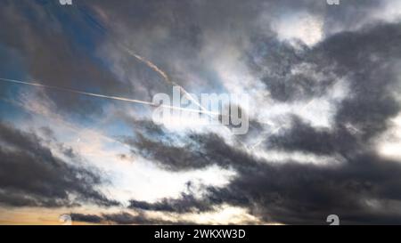 Flugzeug mit Kondensstreifen, die an einem bewölkten Tag fliegen Stockfoto