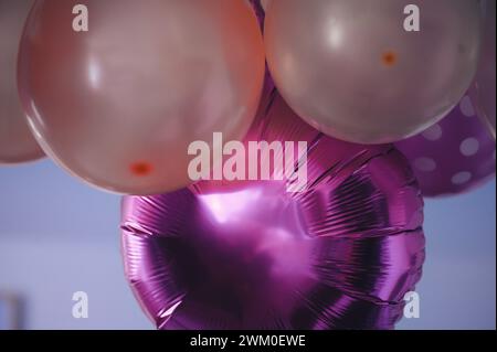Ballons in Herzform in violetten und rosa Tönen, gefüllt mit Helium, schaffen eine schöne Herzform Stockfoto