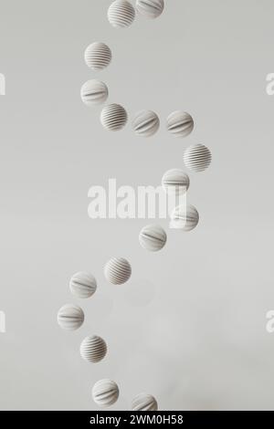 3D-Rendering von gestreiften Kugeln, die vor weißem Hintergrund schweben Stockfoto