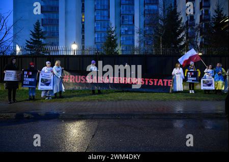 Ukrainer Protestieren Zum Zweiten Jahrestag Der Russischen Invasion. Die Demonstranten halten ein Banner, das besagt, dass Russland ein Terrorstaat ist, während sie sich am zweiten Jahrestag der umfassenden russischen Invasion der Ukraine in Warschau, Polen, am 24. Februar 2024 versammeln. Ein Dutzend Demonstranten, vor allem ukrainische Bürger, die in Polen leben, veranstalteten früh am Morgen einen Protest, indem sie vor einem Wohngebäude, in dem russische Diplomaten leben, Geräusche von Luftangriffsirenen und Explosionen spielten. Warschau Polen Copyright: XAleksanderxKalkax Stockfoto