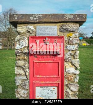 A Red Victorian Ära Postbox / Queen Victoria Post Box auf Sarratt Green, Hertfordshire, England, Großbritannien. Briefkasten Für Wandmontage In Queen Victoria Aus Gusseisen Stockfoto