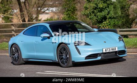 Milton Keynes, UK-Feb 24th 2024: 2021 blaues Porsche Taycan Turbo Elektroauto fährt auf einer englischen Straße Stockfoto