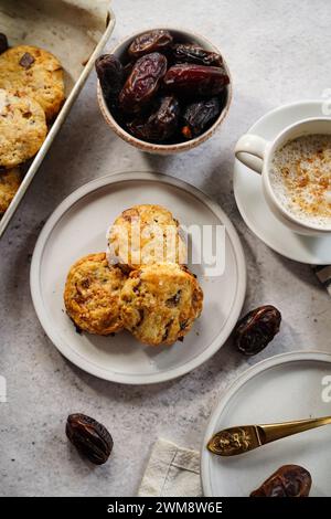 Hausgemachte Dattelscones serviert mit einer Tasse Kaffee und frischem Dattelobst Stockfoto