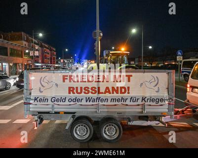 25. Februar 2024, Brandenburg, Frankfurt (oder): Ein Banner mit der Aufschrift „Frieden mit Russland! Kein Geld und keine Waffen mehr für Kriege!“ Hängt am Anhänger eines Handwerkers, der zusammen mit Bauern und anderen Menschen nachts die Zufahrt zur deutsch-polnischen Grenzbrücke in Frankfurt (oder) blockierte. Als Reaktion auf die Sparpläne der Bundesregierung haben Landwirte, Handwerker und Handwerker erneut zu Protesten aufgerufen. Foto: Patrick Pleul/dpa Stockfoto