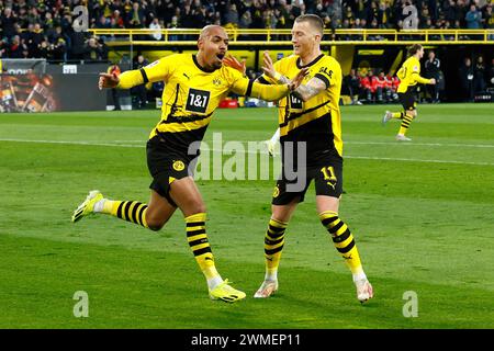 Dortmund, Deutschland. Februar 2024. Donyell Malen (L) von Borussia Dortmund feiert mit seinem Teamkollegen Marco Reus am 25. Februar 2024 in Dortmund das erste Bundesliga-Spiel zwischen Borussia Dortmund und TSG Hoffenheim. Quelle: Joachim Bywaletz/Xinhua/Alamy Live News Stockfoto