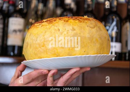 Eine hausgemachte 15 cm große Tortilla Espanola - spanisches Omelett aus 30 Eiern und 7 kg Kartoffel. Es wird in einer kleinen Bar serviert, die Bar Santos gegenüber Stockfoto