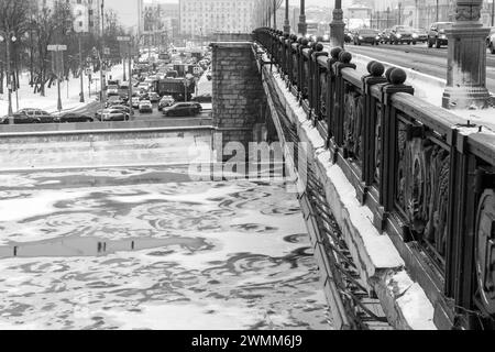 Eisdriften auf dem winterlichen Moskauer Fluss unter der Bolschoi-Kamenny-Brücke auf dem Kreml-Damm. Schwarz-weiß. Stockfoto