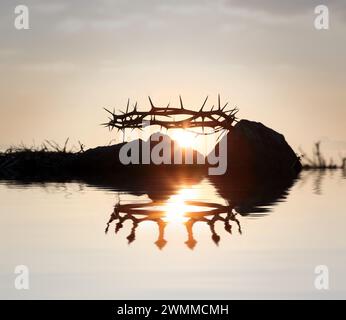 Die Dornenkrone symbolisiert das Leiden Jesu Christi und die Krone des Himmels spiegelt sich im Wasser, der Karwoche und im Hintergrund wider Stockfoto