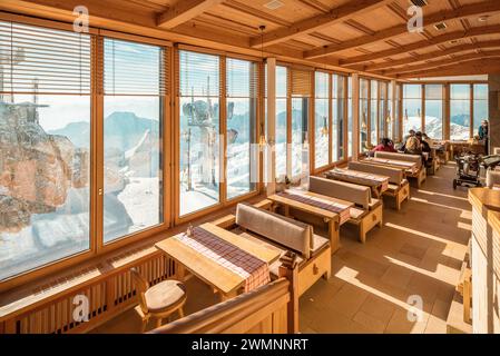 Panoramarestaurant auf der Zugspitze. Blick auf den schneebedeckten Gipfel durch große Fenster. Stockfoto