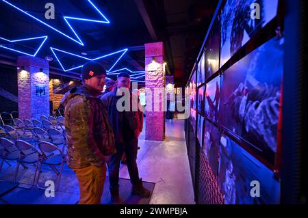 ZAPORIZHZHIA, UKRAINE - 26, 2024 - Soldaten nehmen an der Eröffnung der Fotoausstellung "an der Frontlinie des Lebens" Teil, die Fotos zeigt, die während der Kampfeinsätze des Militärs aufgenommen wurden, organisiert von Soldaten der 116. Separaten Mechanisierten Brigade, im Orbita-Kulturpalast in Zaporischzhia, Südostukraine. Stockfoto