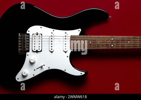 Nahaufnahme auf elektrischer Gitarre über rotem Hintergrund Stockfoto
