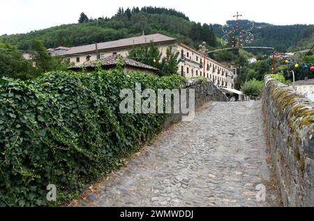 Corias parroquia de Cangas del Narcea. Mittelalterliche Brücke, unten Monasterio de San Juan Bautista (11.-17. Jahrhundert). Asturien, Spanien. Stockfoto