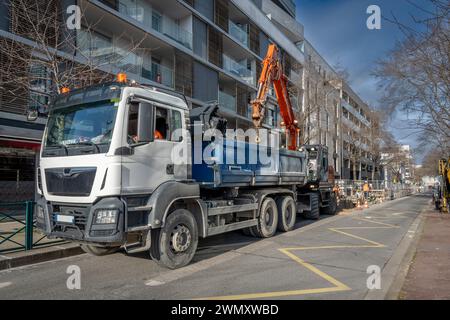 Gennevilliers, Frankreich - 02 02 2024: Straßenbauarbeiten im Hintergrund. Heizungsnetzentwicklung mit Lkw und Baukran Stockfoto