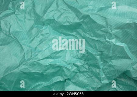 Сrumpled Papierstruktur grün. Textur von zerknittertem Papier. Zerknittertes Papier. Faltendes Papier. Stockfoto