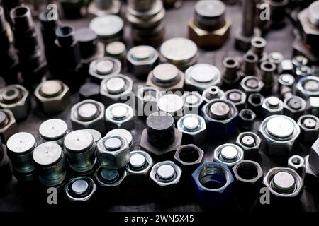 Closeup still life of metal hex nuts and bolts on table, industrial background Stockfoto