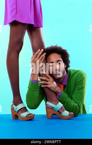 Paare, Studio und Vintage mit Farbe, Mode und Liebe mit Beziehung und Betteln. Afrikanischer Mann, Frau und Verabredung mit funky, lebhaft und hell Stockfoto