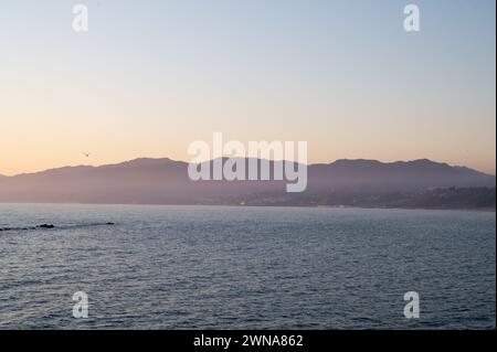 SANTA MONICA, KALIFORNIEN, USA: Die Golden Hour berührt die Santa Monica Mountains oberhalb von Malibu, vom weltberühmten Santa Monica Pier aus gesehen. Stockfoto