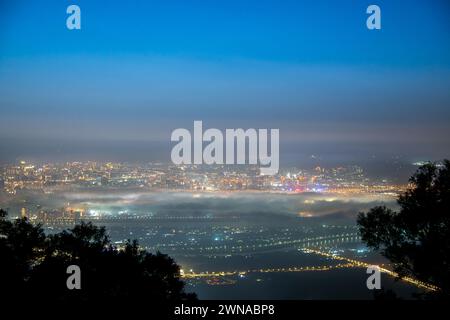 Wolken und Nebel ziehen über die Stadt, und das bunte glasierte Licht leuchtet. Genießen Sie den Sonnenuntergang und das Wolkenmeer. Zhongzhengshan Wander Trail, Taipeh Stadt Stockfoto