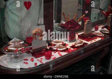 Vitrine mit Herzen, die Süßigkeiten und Geschenke zum Valentinstag zeigt, ideal zum Ausdruck von Liebe und Wertschätzung. Stockfoto