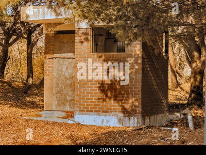 Alte baufällige öffentliche Backsteintoilette im Waldpark am sonnigen Tag in Südkorea Stockfoto