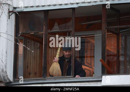 Sankt Petersburg, Russland. März 2024. Ein Anwohner sah, wie er sein Fenster nach einem angeblichen Drohnenangriff säuberte, was von lokalen Medien im Bezirk Krasnogwardeiski berichtet wurde. Das russische Ministerium für Notsituationen ergreift Sicherheitsmaßnahmen rund um das Gebäude. (Foto: Stringer/SOPA Images/SIPA USA) Credit: SIPA USA/Alamy Live News Stockfoto