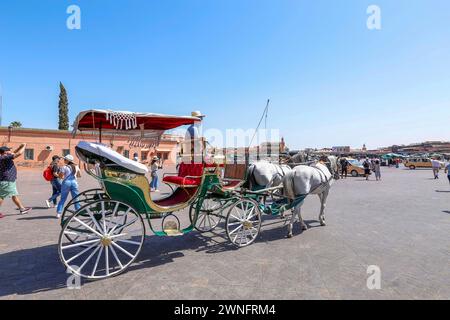 Marrakesch, Morroco - 28. Mai 2019 - farbenfrohe Kutsche und Touristen auf dem traditionellen Jamaa el Fna Platz (auch Jemaa el-Fnaa, Djema el-Fna oder Djemaa el-F) Stockfoto