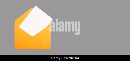 Weiße Karte, leere Postkarte im offenen orangefarbenen Umschlag. Banner-Hintergrund, Kopierbereich. Stockfoto