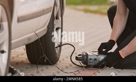 Man Pumpt Den Reifen Mit Einer Tragbaren Pumpe Als Fahrer Auf Stockfoto