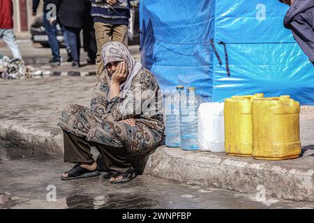 Rafah, Gazastreifen, Palästinensische Gebiete. März 2024. Die Palästinenser sammeln Wasser aus einer Wassertankstelle, wo die Menschen aufgrund des Krieges unter Wasserknappheit leiden. Die Gesamtzahl der Todesopfer in Gaza hat seit Beginn des Krieges am 7. Oktober 30.000 überschritten, so das Gesundheitsministerium des Streifens. Auch in dieser Woche wurden weitere Details über eine mögliche neue Waffenstillstandsvereinbarung bekannt, die vor dem Ramadan beginnen könnte, bis weitere Verhandlungen zwischen Israel, Hamas und ausländischen Mittlern abgeschlossen sind. (Kreditbild: © Saher Alghorra/ZUMA Press Wire) NUR REDAKTIONELLE VERWENDUNG! Nicht für kommerzielle ZWECKE! Stockfoto