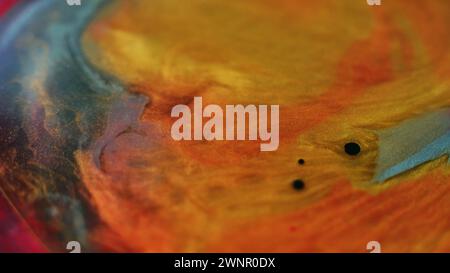 Glitter Fluid Spritzer Ölfleck Tinte Wassermischung orange Stockfoto