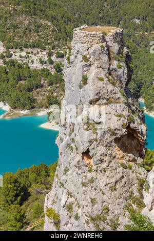 Ruinen eines runden Burgturms über dem blauen See in Guadalest, Spanien Stockfoto