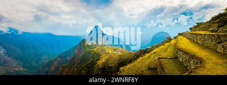 Ein breites 3:1 Panoramafoto mit Blick auf Machu Picchu, eine Inka-Stätte aus dem 15. Jahrhundert, die 2.430 Meter über dem Meeresspiegel auf einem Bergkamm über dem Uru liegt Stockfoto